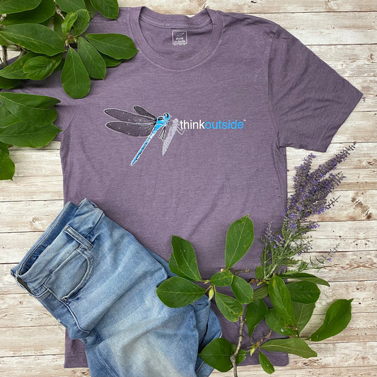 Hand drawn blue dragonfly with lacy wings on a super soft heather purple nature lover's graphic tee. Features the phrase Think Outside.