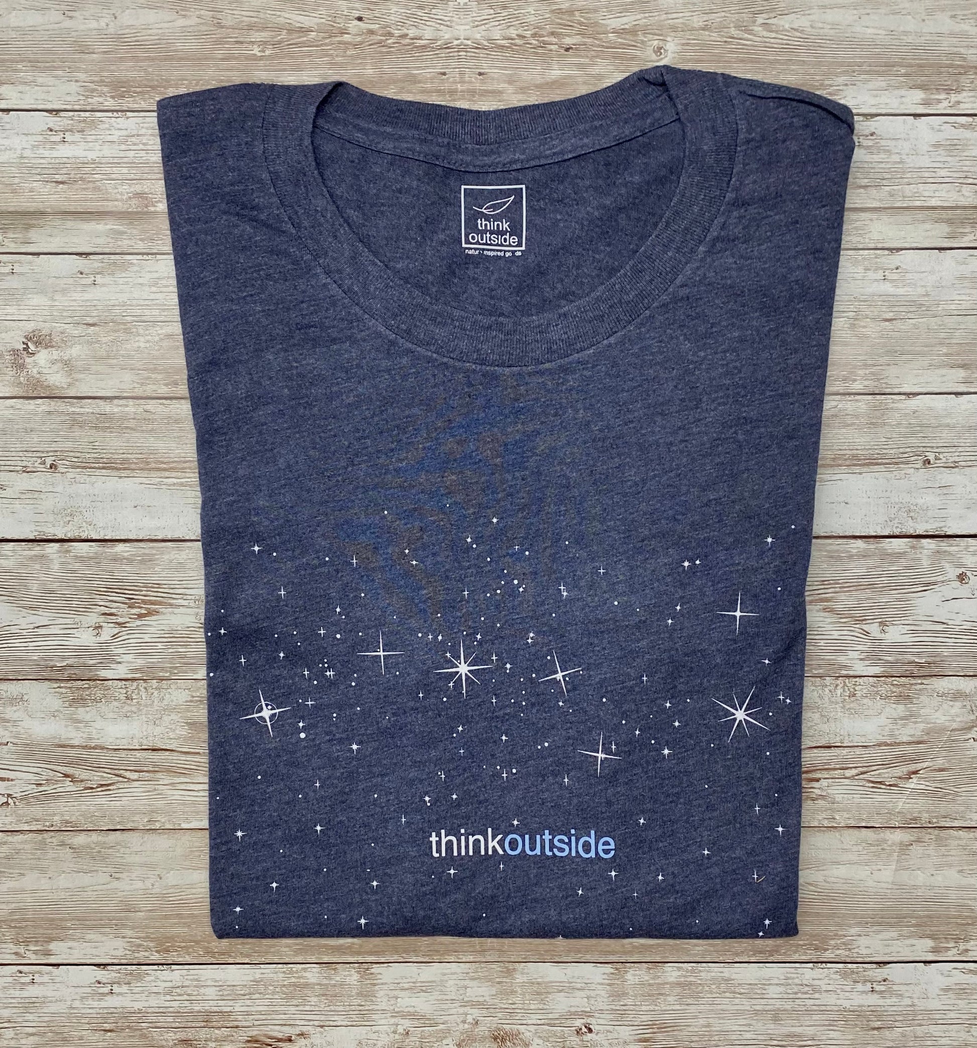 A night sky full of stars with the Big Dipper on a super soft heather midnight navy graphic tee for outdoor lovers.Features the phrase Think Outside.